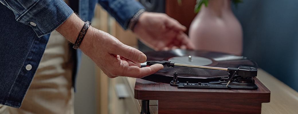 Image of senior's hands putting a record on a record player